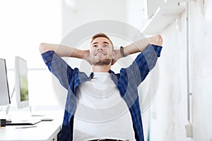 Happy creative man with computer at office