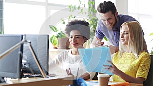 Happy creative team with computers in office