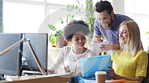 Happy creative team with computers in office