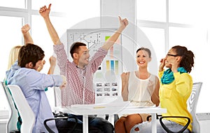 Happy creative team or designers at office