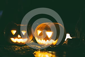 Happy and creepy traditional Halloween jack-o-lantern pumpkins