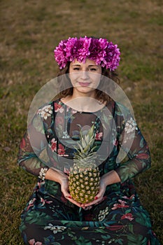 Happy curvy girl with a pineapple and a flower crown