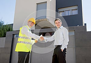 Happy customer smiling and constructor foreman worker shacking hands as agreement