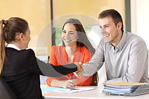 Happy customers handshaking after a deal