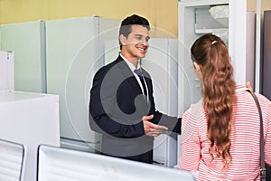 Happy customers looking at large fridges