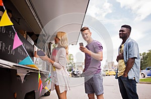 Happy customers queue at food truck