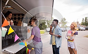 Happy customers queue at food truck