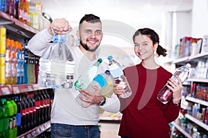 Happy customers standing at beverages section