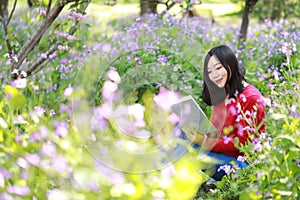 Šťastný roztomilý asijský čínština příroda krásná žena v jaro požívat volný číst kniha 