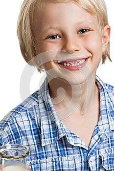 Happy cute boy with milk moustache.