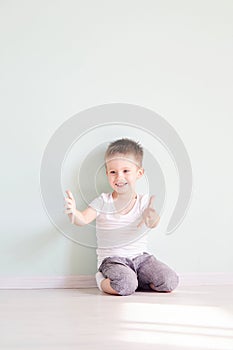 Happy cute child reaching out his palms and catching something.