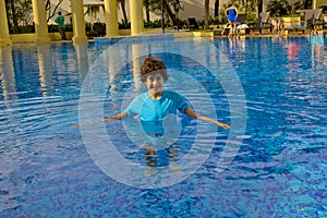 Happy cute child in swimming pool