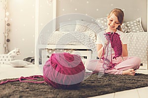 Happy cute girl knitting