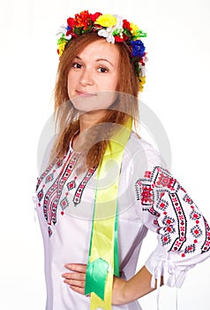 Happy cute girl in the Ukrainian national costume and Ukrainian flag