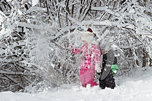 Kid walking and playing in snowy winter forest, winter wonderland, family travel