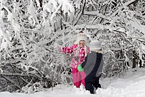 Kid walking and playing in snowy winter forest, winter wonderland, family travel