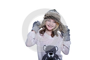 Happy cute kid posing in the studio isolated on white background. Wearing winter clothes. Knitted woolen sweater, scarf, hat