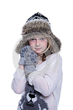 Happy cute kid posing in the studio isolated on white background. Wearing winter clothes. Knitted woolen sweater, scarf, hat