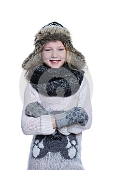 Happy cute kid posing in the studio isolated on white background. Wearing winter clothes. Knitted woolen sweater, scarf, hat.