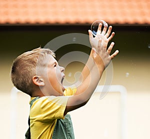 Happy cute kid with soap bubble