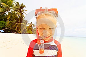 Happy cute little boy snorkel at beach