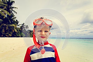 Happy cute little boy snorkel at beach