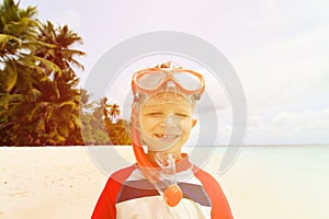 Happy cute little boy snorkel at beach