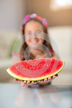 Happy cute little girl eating watermelon