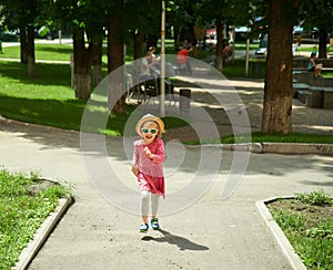 Happy cute little girl running in the park. Happiness.