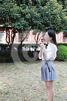 Happy cute lovely beautiful young girl high school college student enjoy free time eat icecream