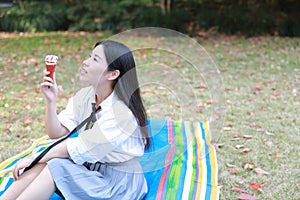 Happy cute lovely beautiful young girl high school college student enjoy free time eat icecream