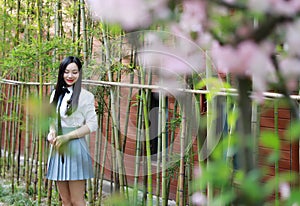 Happy cute lovely beautiful young girl high school college student enjoy free time ride a bike at school