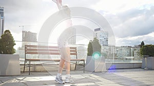 Happy cute millenial hipster girl having fun outdoor at city streets urban background. Beauty woman spinning, jumping