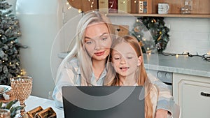 Happy cute mother and daughter spending time together at christmas holiday.