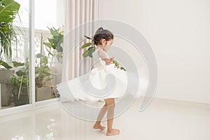 Happy cute preschooler girl dancing in living room