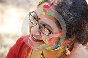 Happy cute smiling woman on Holi color festival.