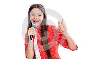 Happy cute teen girl singing a song on microphone. Close-up portrait of trendy fashionable girl singing karaoke