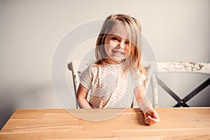Happy cute toddler girl playing in kitchen