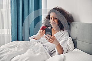 Happy cute woman reading a text message