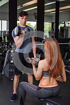 Happy cutie athletic girl , execute exercise with dumb-bells