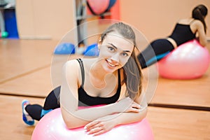 Happy cutie athletic girl , execute exercise and smile, in a sport-hall