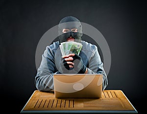 Happy cybercriminal man holding euro
