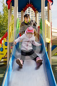 Happy dad and daughter in the playground