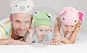 Happy dad with kids in funny hats