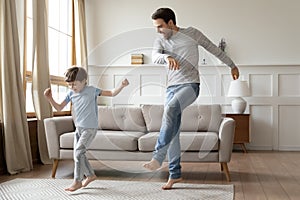 Happy dad and little son dance at home