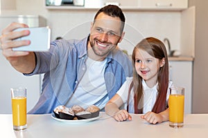 Happy Daddy And Daughter Making Selfie Having Breakfast In Kitchen
