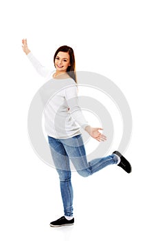 Happy dancing teenager with arms up