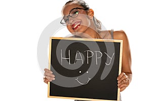 Happy dark skinned woman holding blackboard