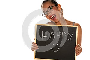 Happy dark skinned woman holding blackboard