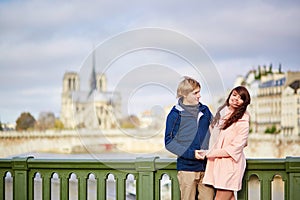 Happy dating couple walking in Paris